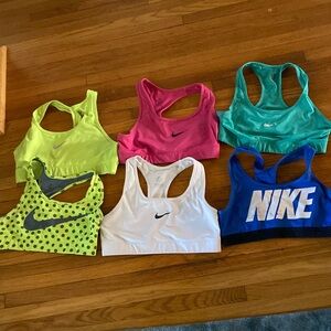 6 Nike sports bras. Check photos for signs of wear on logos.